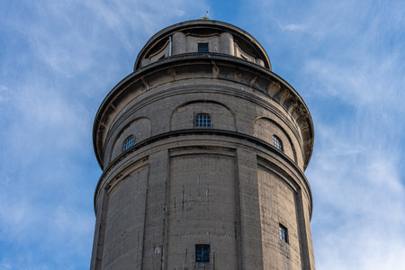 Close Up Of Historic Concrete Tower With Windows Under Blue Skyの写真素材