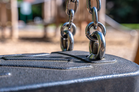Swing Chain Links On Black Seat, Metal Hardware Safety Detail At Outdoor Park Playgroundの写真素材