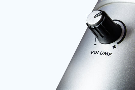 Black Volume Control Knob On Metallic Audio Device Macro Closeup With Plus Minus Scale, Sound Level Adjustment Technology Detail Isolatedの写真素材