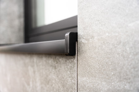 Exterior Window Sill Detail With Dark Trim And Gray Stone Wall In Modern Building Architectureの写真素材