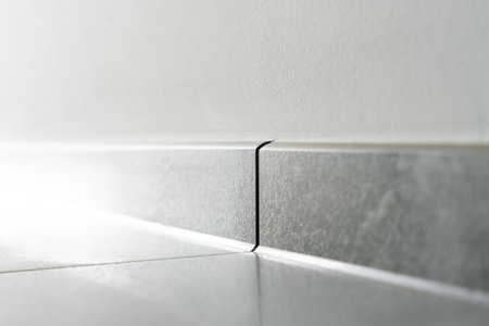 Tile Baseboard And Wall Joint Close-Up Showing Clean Finish Modern Interior Construction Detail And Material Qualityの写真素材