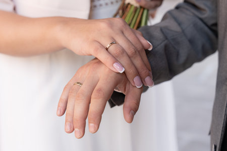 Bride And Groom Showing Matching Wedding Rings With Hands Together After Marriage Ceremony Symbolizing Unityの写真素材