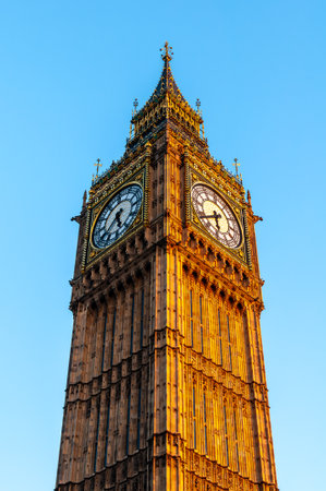 Big Ben Clock Tower In Golden Evening Light Against Clear Blue Sky London Historic Symmetrical Landmarkの写真素材