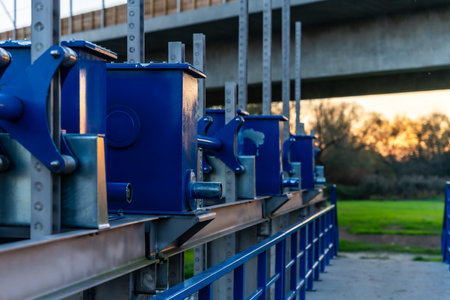 Blue Industrial Mechanisms On Metal Platform At Sunset For Engineering And Heavy Equipment Applicationsの写真素材
