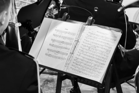 Classical Music Sheet On Orchestra Stand With Musician During Concert At Philharmonicの写真素材