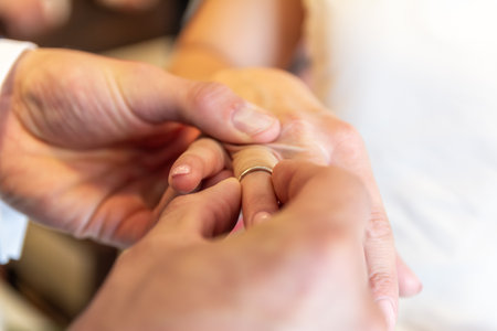 Groom Putting Wedding Ring On Bride Finger Closeup Romantic Marriage Ceremonyの写真素材