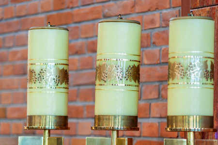 Liturgical Church Candles With Grapevine Motif Against Brick Wall Religious Decoration