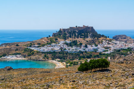 Lindos Rhodes Greece Acropolis Above White Village And Turquoise Bay Beach On Aegean Coast Summer Travel Landscape Backgroundの写真素材