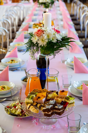 Dessert Table With Floral Candle Centerpiece And Sweets Served For Celebration Event