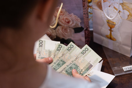 Child Counting Polish Money Gift Received During Communion Celebration Event Indoorsの写真素材