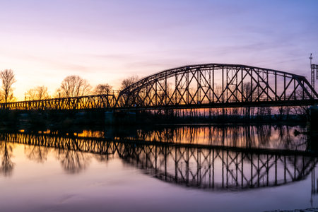Old Steel Bridge Truss Silhouette At Sunset Over River Reflection, Twilight Landscape Travelの写真素材