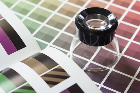 A magnifier on a color chart book