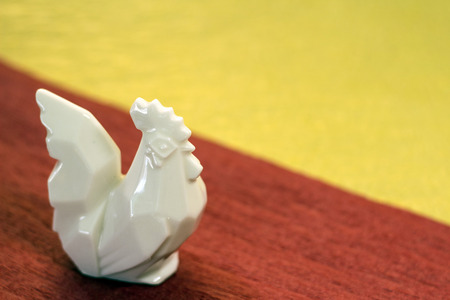 A white pottery rooster on the Japanese handmade paperの写真素材