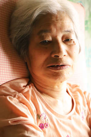 Senior woman relaxing in a nursing bedの写真素材