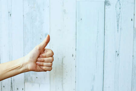 Woman hand with thumb up gestureの写真素材