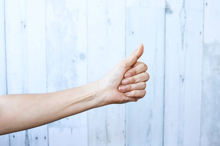 Woman hand with thumb up gestureの写真素材