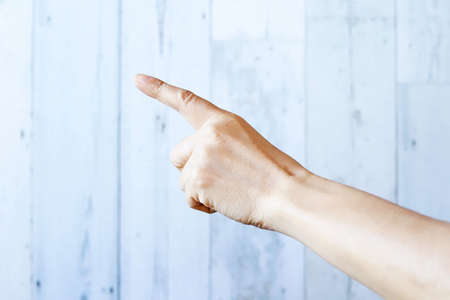 Woman hand with the index finger pointing upの写真素材