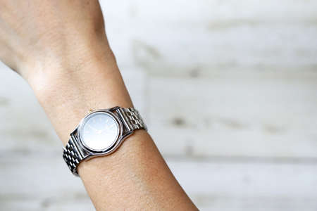 Woman Hand Wearing Silver Wrist Watchの写真素材