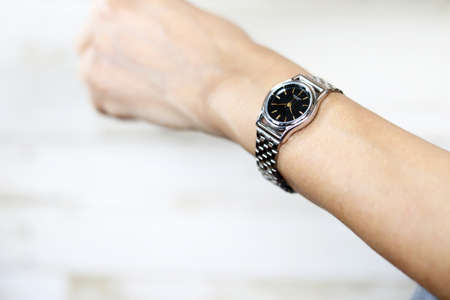 Woman Hand Wearing Silver Wrist Watchの写真素材