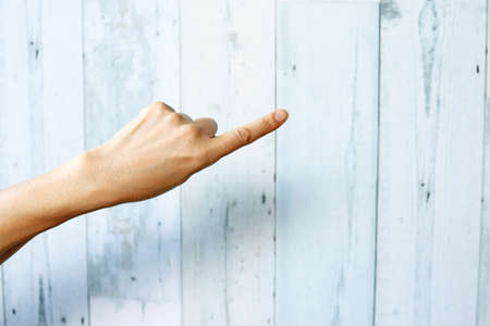 Woman hand with the index finger pointing up