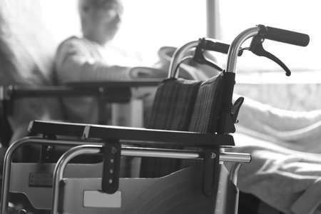 Elderly woman with dementia playing with a blanket while relaxing in a nursing bed