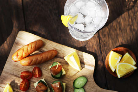 A Glass filled with whiskey soda and finger foodsの写真素材