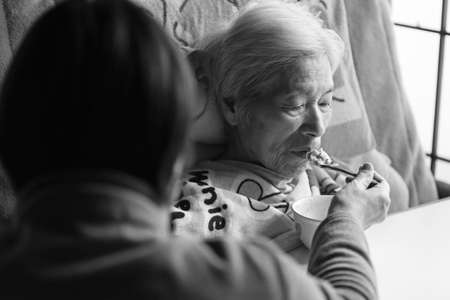 Elderly women receiving meal assistance Home care Elderly careの写真素材