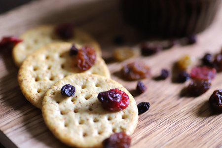 Crackers and dried fruit snacks on the wooden Cutting board