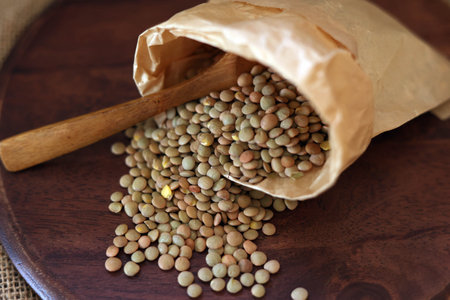 Lentils spilling out of a paper bagの写真素材
