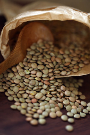 Lentils spilling out of a paper bagの写真素材