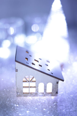 Christmas tree and lighted toy houseの写真素材