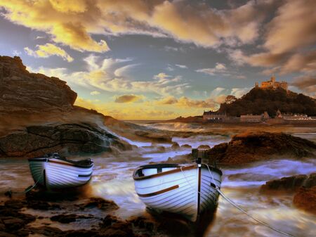 Beautiful evening at St Michael's Mount Cornwall, two boats rest from a hard days work taking hoiliday makers to the islandの写真素材
