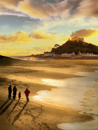 Beautiful evening at St Michael's Mount Cornwall, a family take a walk to watch the sun set,の写真素材