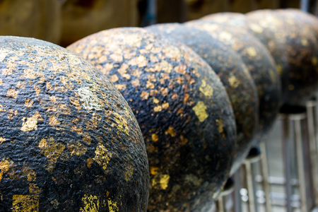 "LUUK NIMIT" - round stones buried in the ground to mark the sacred limits of a Buddhist templeの写真素材