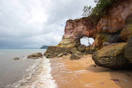Natural hole on colorful rocks at Laem Chamuk Khwai in Khao Thong,Mueang Krabi District,Krabi province,southern Thailand.の写真素材
