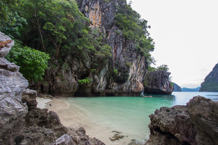 Small bay surrounded by intricate limestone,soft white sand beach and emerald color sea at Lading island(Paradise island) in Krabi province,Southern Thailand.の写真素材