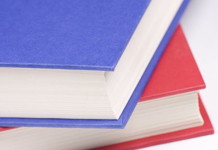 Stacked books on white background
