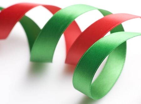 Green and red ribbon curling on whiteの写真素材
