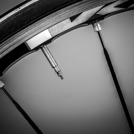 Fragment of a frame and parts of a road bike. The frame is made of titanium and there are several...