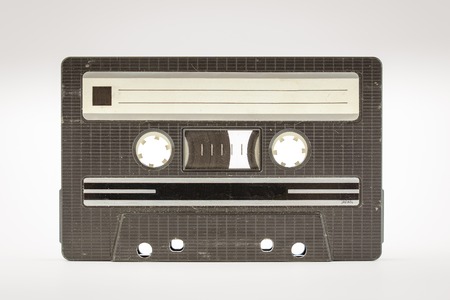 Old vintage cassette tape that is scratched and full of dust particlesの写真素材