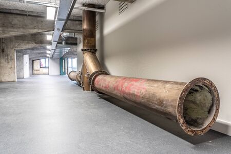 Interior of a former factory that has been restored. The old constructions and brick walls are visible, supplemented with restored and new parts. It continues to give a grungy and rundown impression.の写真素材