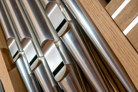 Close up image of round steel pipes of an organ in the church. Also called organ pipes. They are set in a wooden frameの写真素材