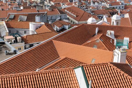 Panoramic image of the Lisbon skyline with the houses with red roof tiles and the sea in the...