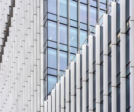A modern skyscraper corporate building  with many windows during daytime