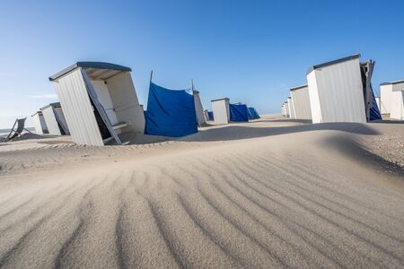 Along the beach of The Netherlands you can find lots of beach houses cabins. Normally they are occupied by tourists who stay there for the weekend or spen their holiday there, now they are often emptyの写真素材