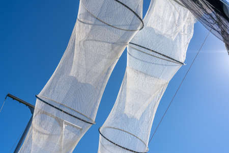 Fishing nets drying in the sun under a clear blue skyの写真素材