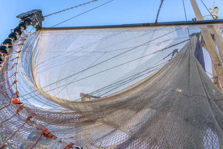 Fishing nets drying in the sun under a clear blue skyの写真素材