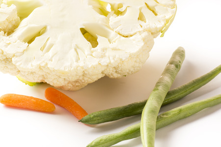 closeup cut  half cauliflower with baby carrots and beansの写真素材