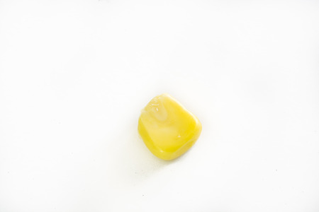 One sweet, fresh, raw, ripe, juicy kernel corn on the white background.の写真素材