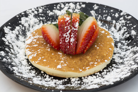 Sugared, delicious, sweet pancake with fresh strawberry.の写真素材